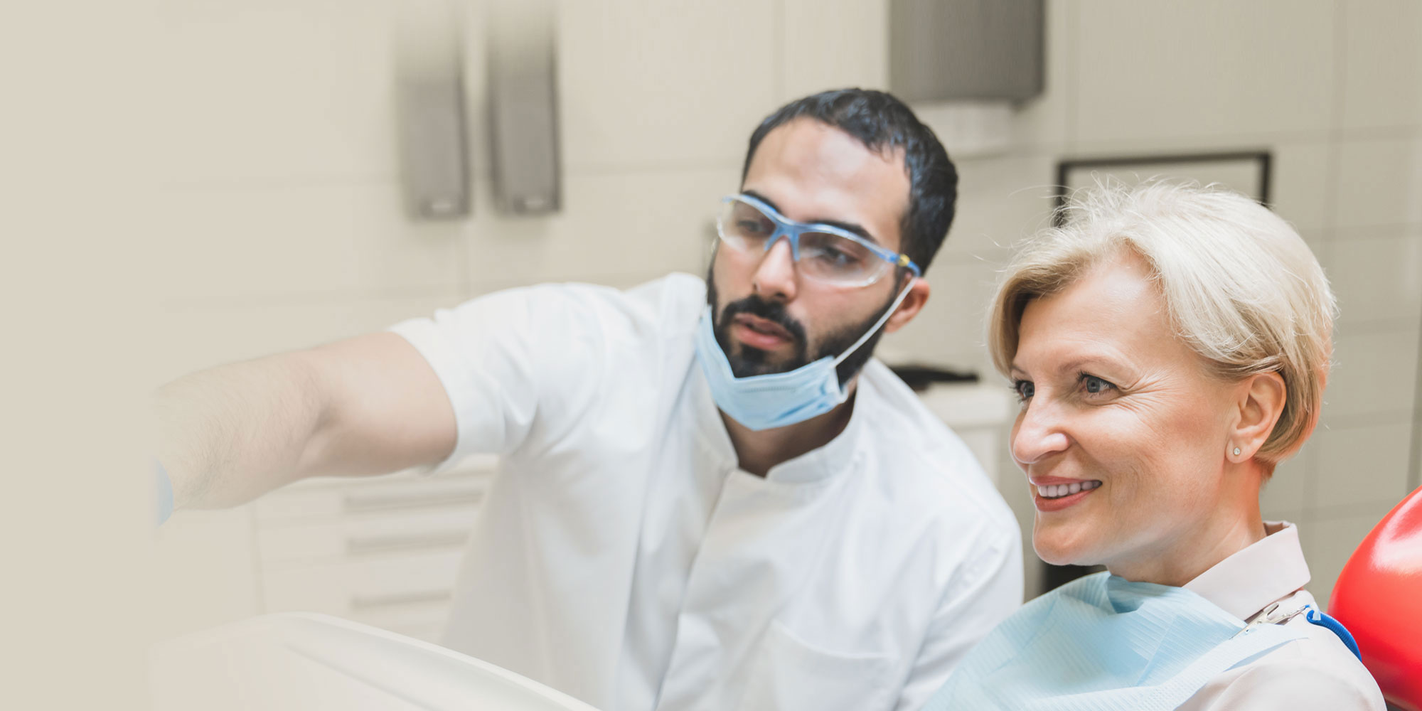 surgeon with female older implant patient showing risk factors