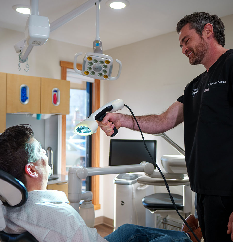 doctor with tech in hand dental