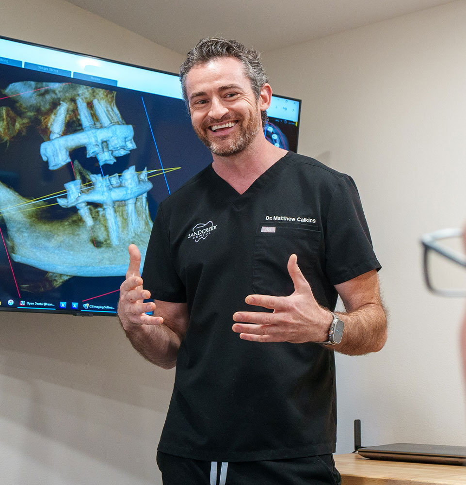 headshot of doctor going over dental procedure information woth patient